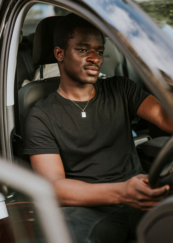 african american saving on car insurance while diriving