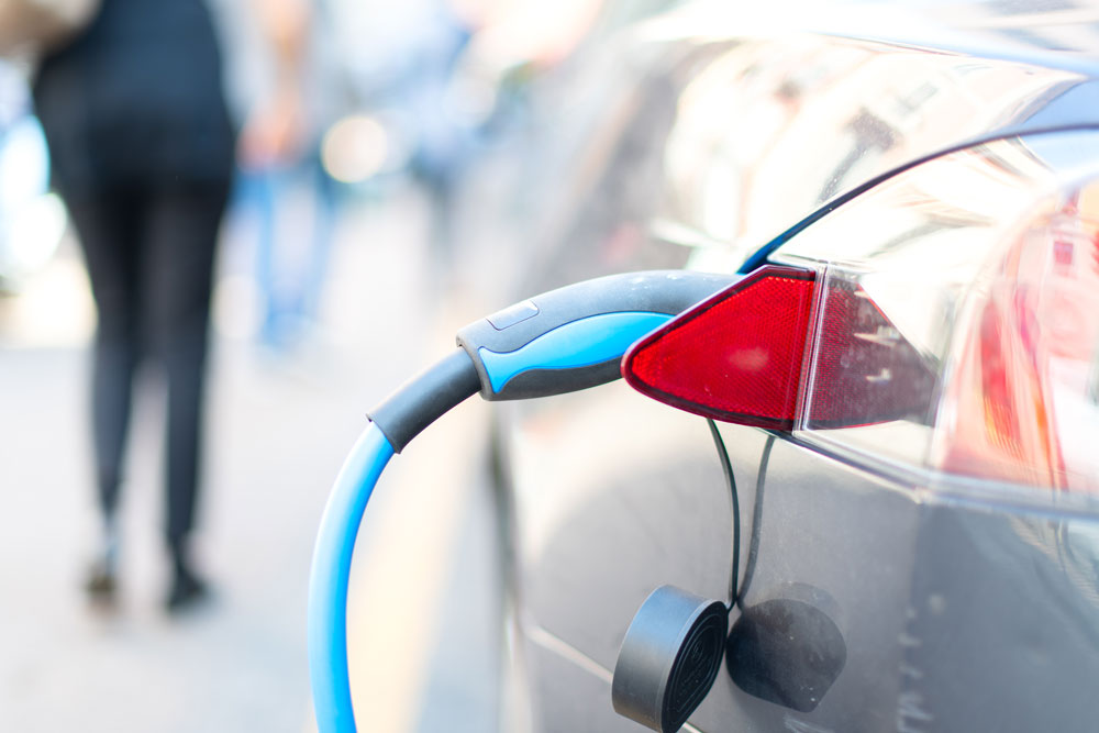 an electric car is charge with low auto insurance