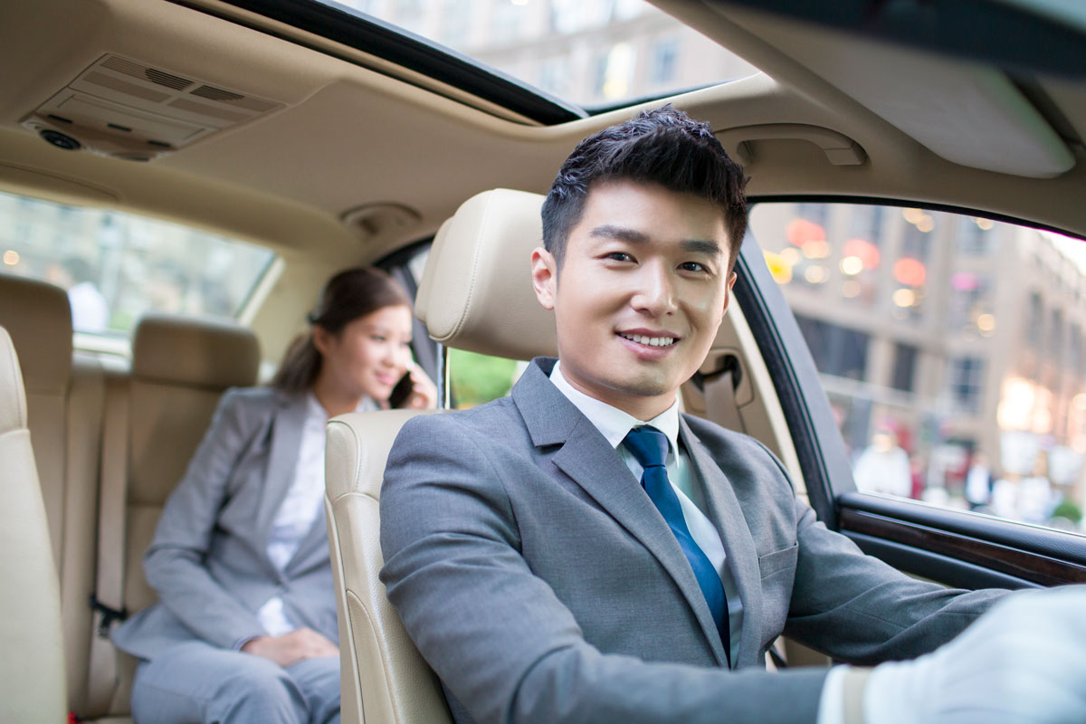 chauffer driving car for a businesswoman