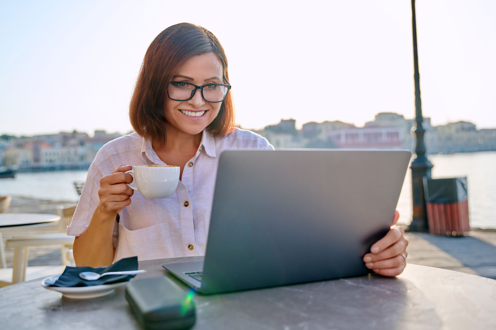 smiling middle aged woman with coffee and health insurance