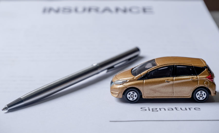 car and pen on insurance